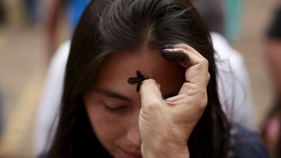 FILE -- A woman receives a cross of ashes during the traditional Ash Wednesday service. (REUTERS/John Vizcaino)